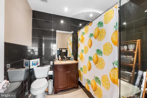 a bathroom with a toilet and a shower curtain
