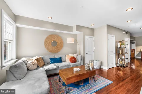 a living room with furniture and wooden floor