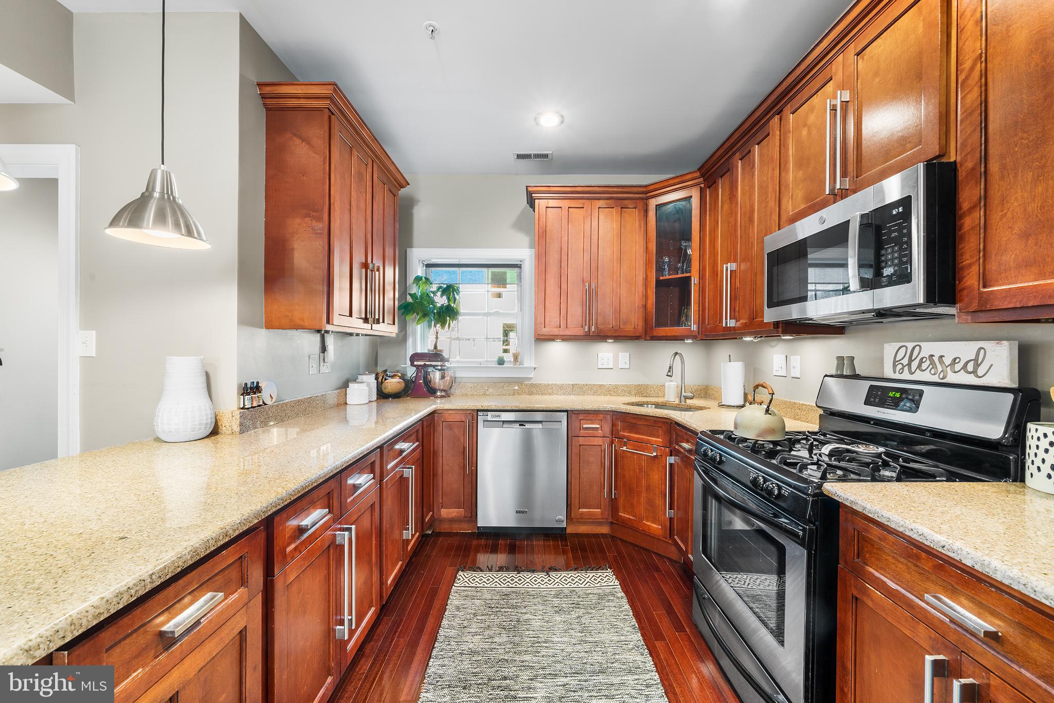 1927 Poplar Street, Unit B Philadelphia, PA 19130 - Photo 9 of 27 a kitchen with stainless steel appliances granite countertop a sink stove and cabinets