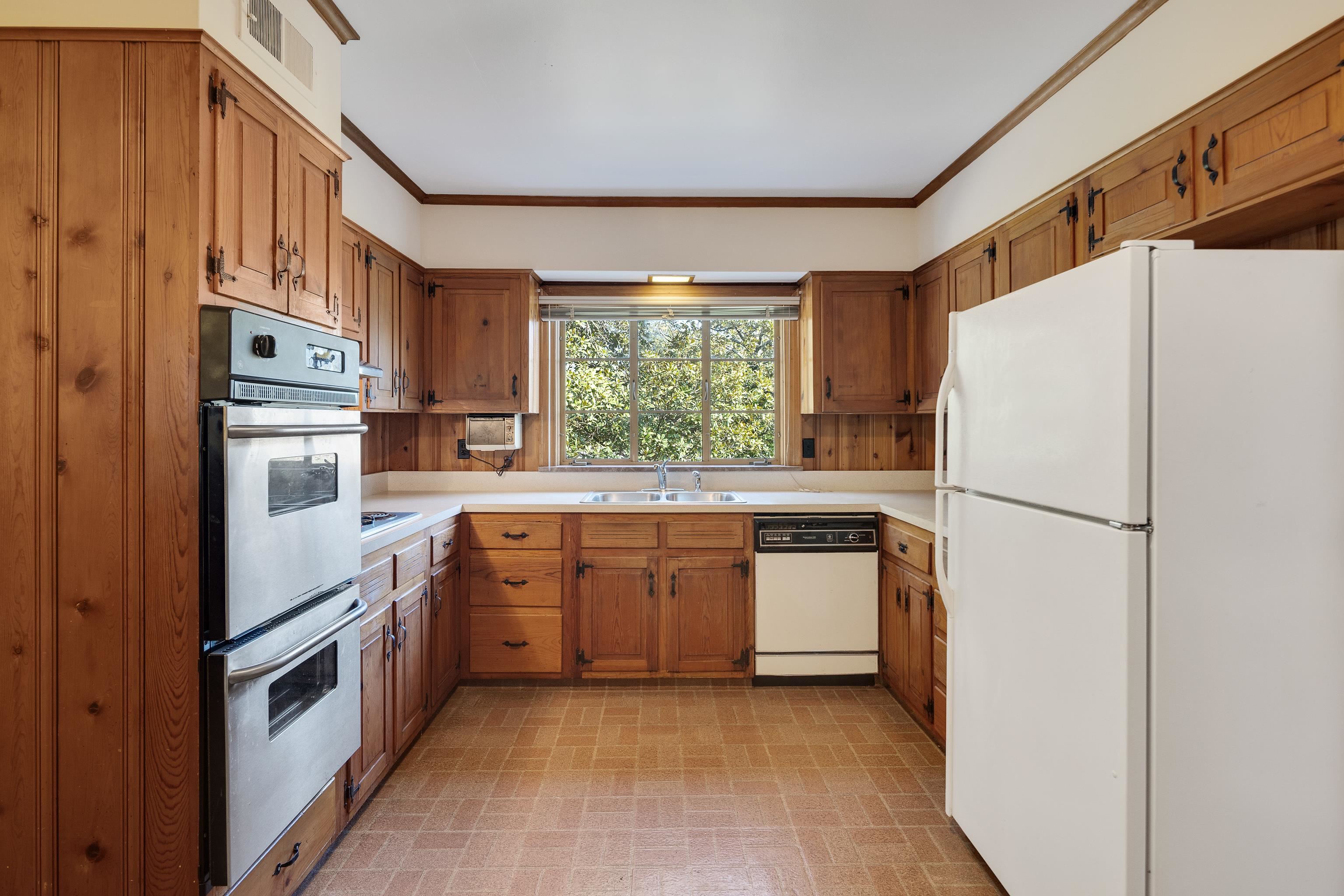 685 South Perkins Road Memphis, TN 38117 - Photo 15 of 40 a kitchen with stainless steel appliances white cabinets and a refrigerator