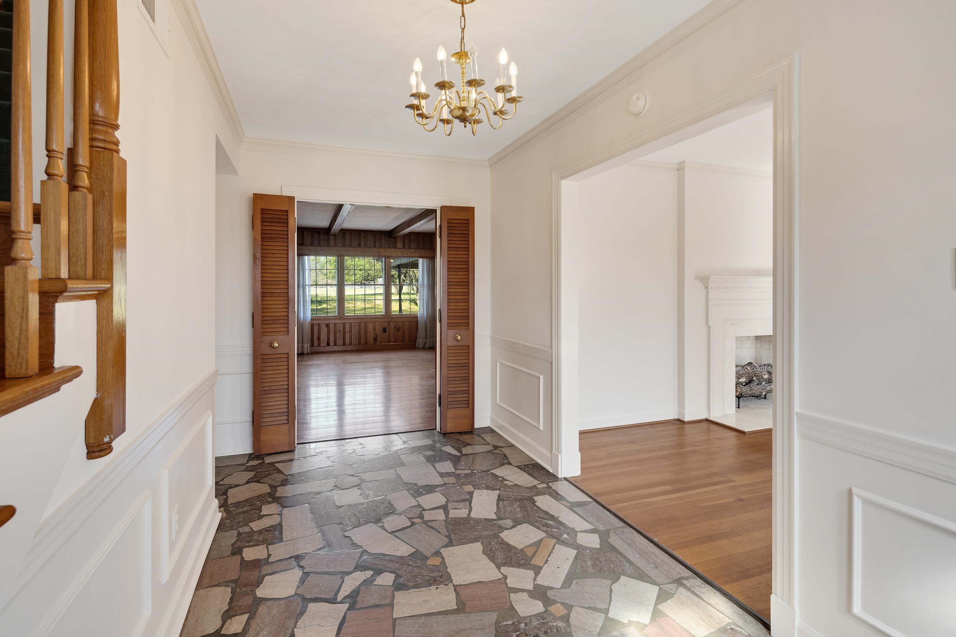 685 South Perkins Road Memphis, TN 38117 - Photo 5 of 40 a view of a hallway with wooden floor and a chandelier