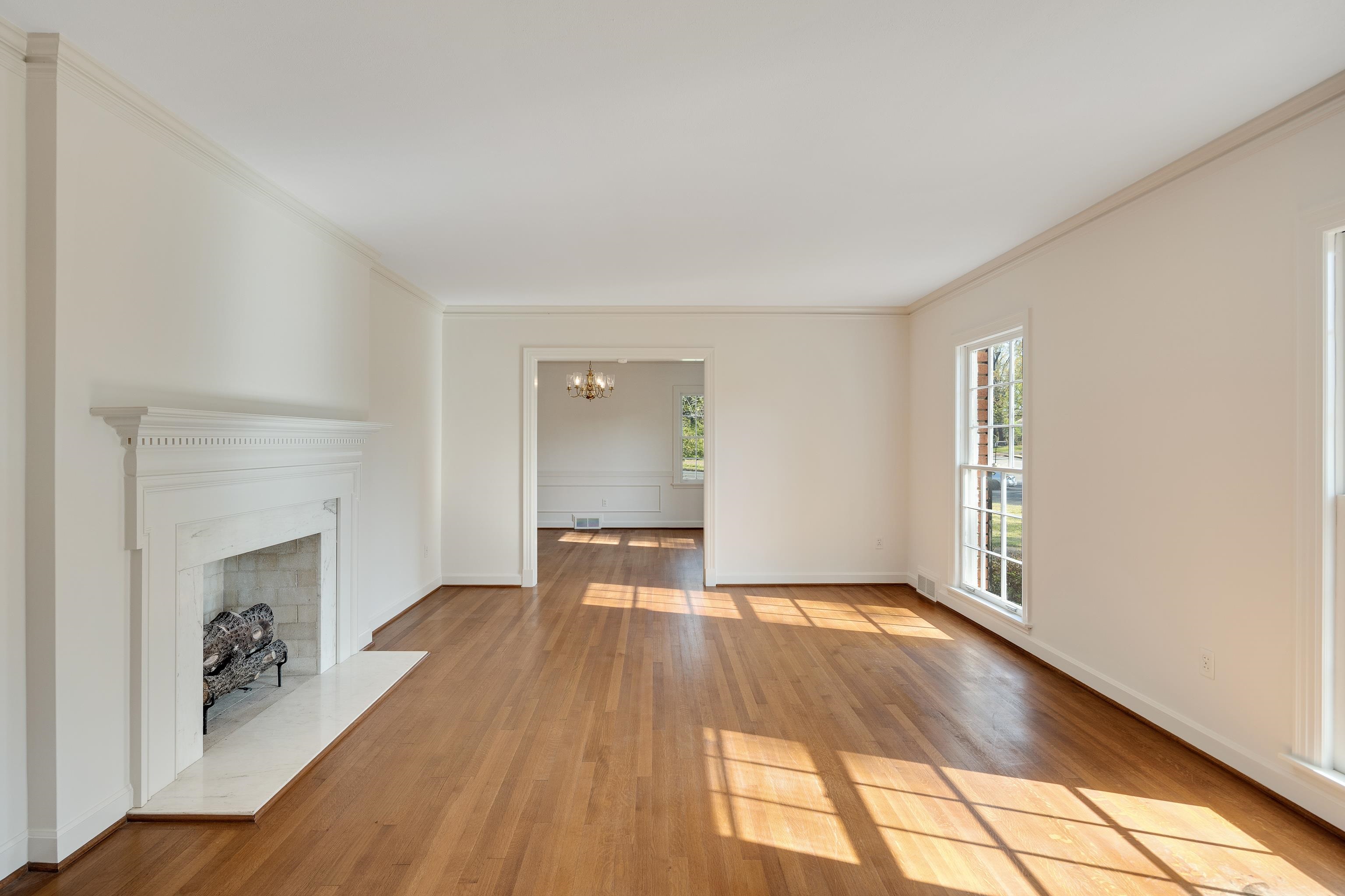 685 South Perkins Road Memphis, TN 38117 - Photo 7 of 40 a view of empty room with wooden floor and fireplace