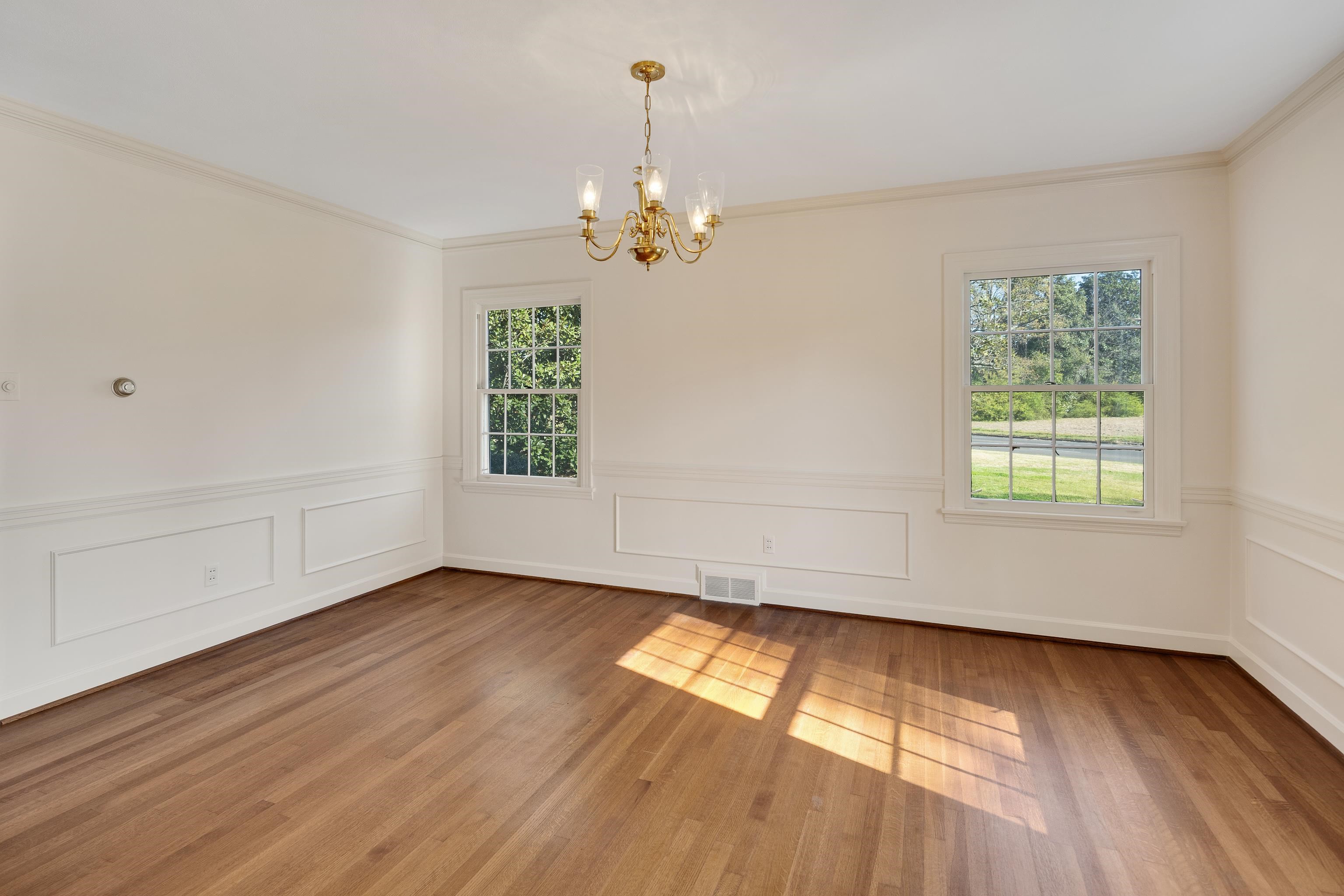 685 South Perkins Road Memphis, TN 38117 - Photo 9 of 40 an empty room with wooden floor chandelier fan and windows