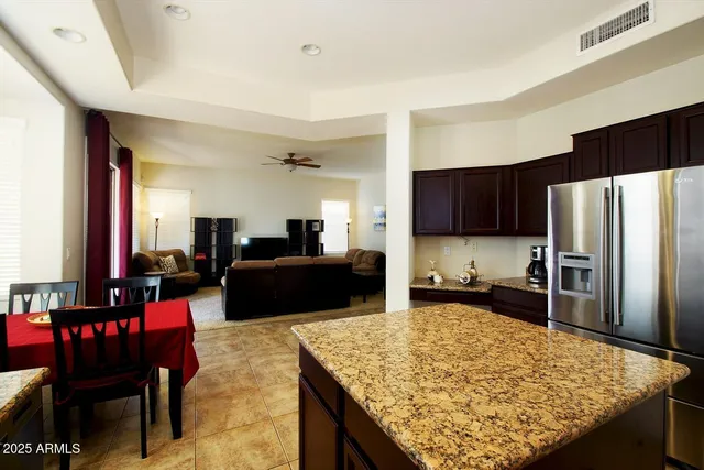a kitchen with kitchen island granite countertop stainless steel appliances and a sink