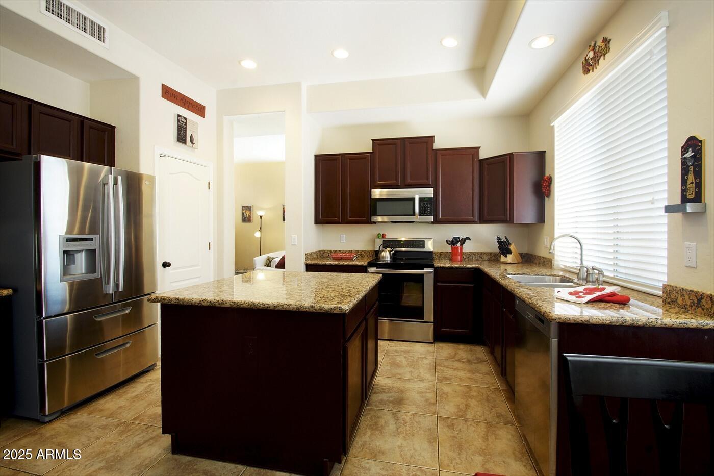 239 West Desert Avenue Gilbert, AZ 85233 - Photo 12 of 38 a kitchen with kitchen island granite countertop stainless steel appliances and a sink