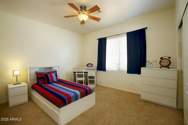 a living room with furniture and a ceiling fan