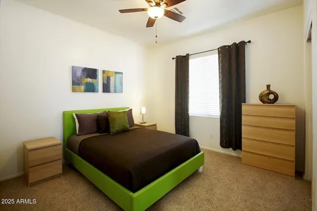 a bedroom with bed and a chandelier