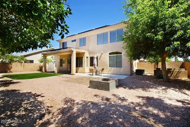a view of a white house with a garden and pathway
