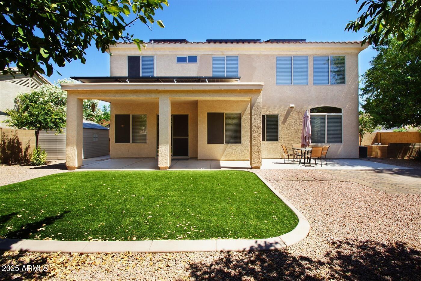 239 West Desert Avenue Gilbert, AZ 85233 - Photo 22 of 38 a view of a white house with a garden and pathway