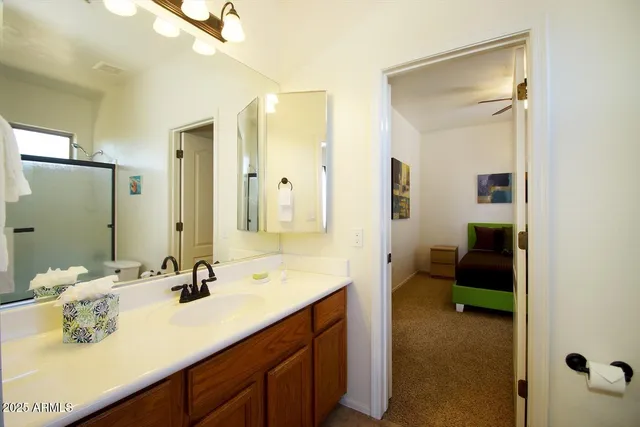 a view of bathroom with a sink and a washer dryer