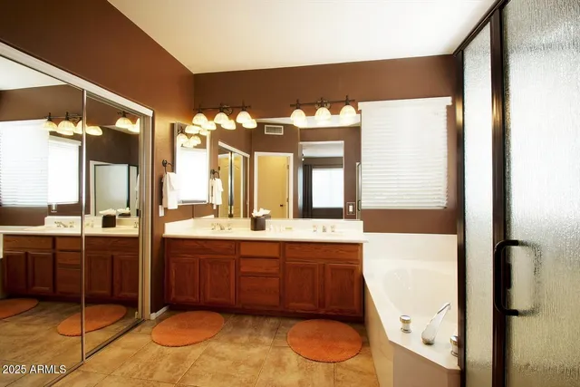 a spacious bedroom with a bed and ceiling fan