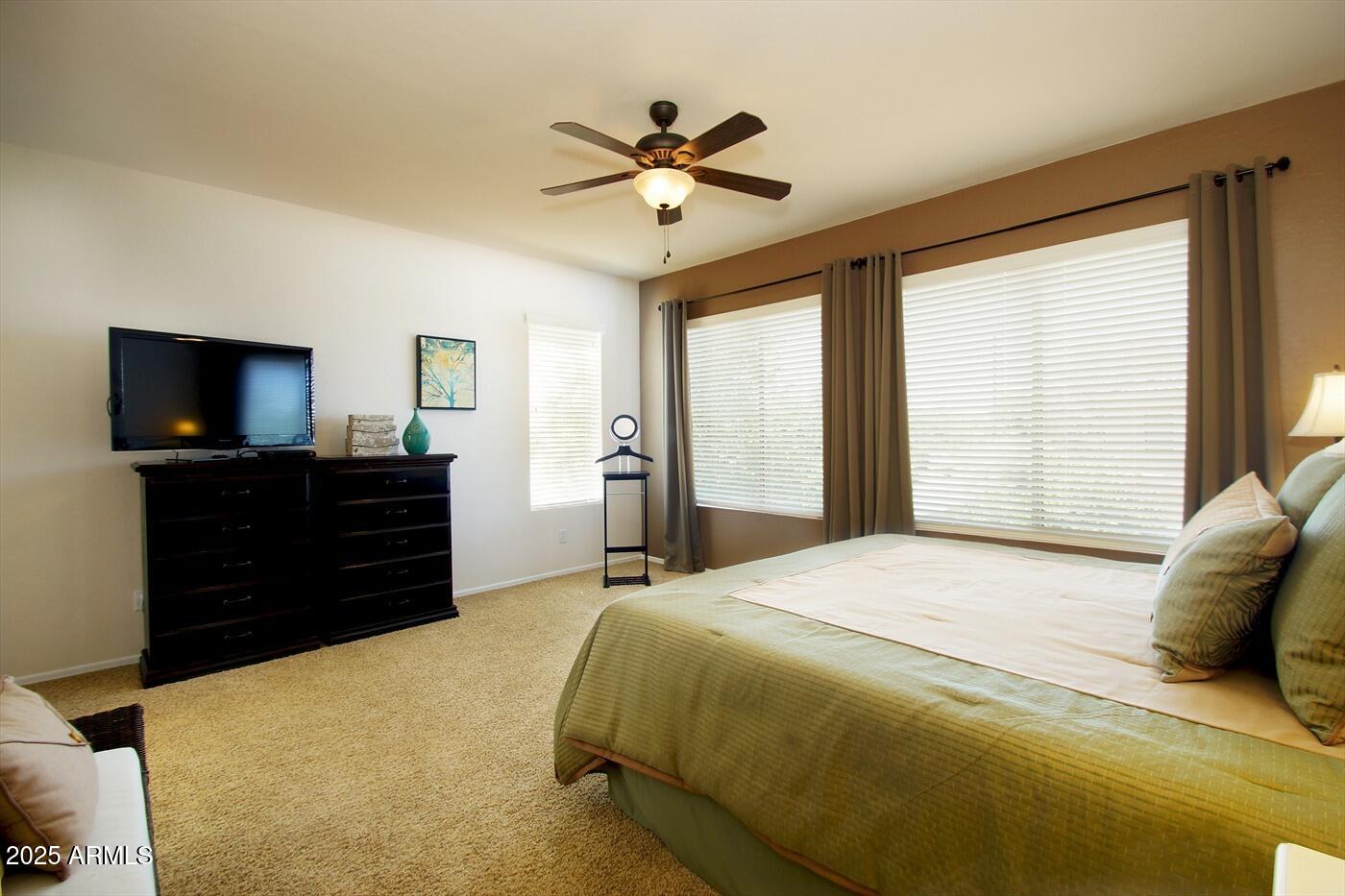 239 West Desert Avenue Gilbert, AZ 85233 - Photo 37 of 38 a bedroom with a bed and a flat screen tv