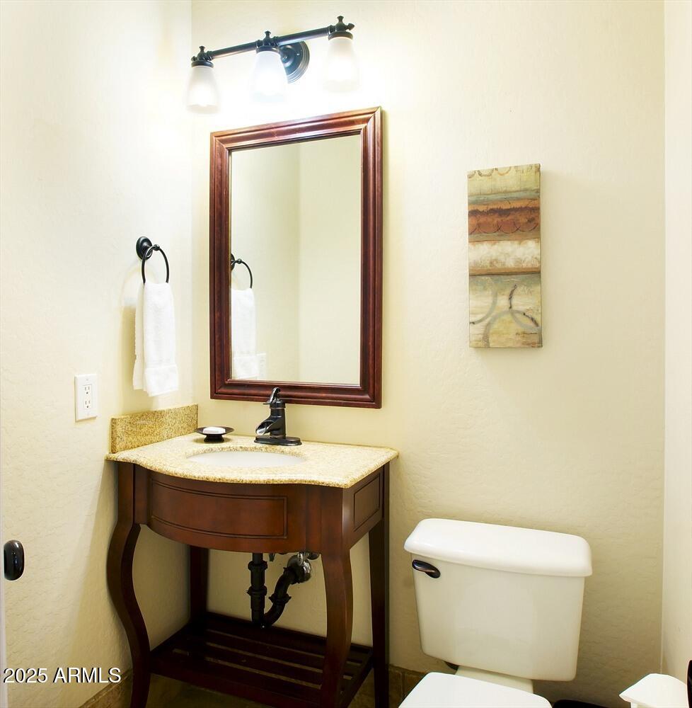 239 West Desert Avenue Gilbert, AZ 85233 - Photo 38 of 38 a bathroom with a toilet a sink and mirror