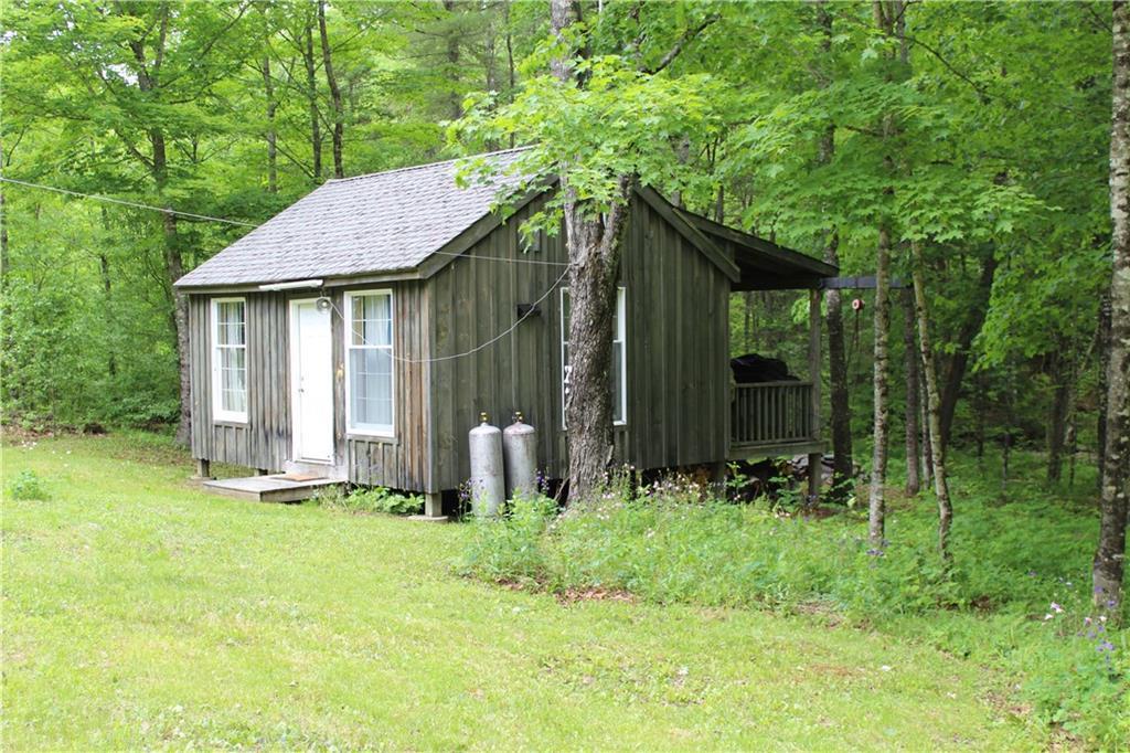 1 York Mill Athens, ME 04912 - Photo 6 of 23 Right side view of camp with covered...