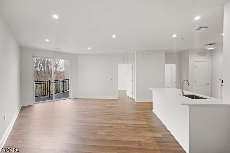 434 Springfield Avenue, Unit 123 Berkeley Heights, NJ 07922 - Photo 19 of 24 a view of a big room with wooden floor and windows