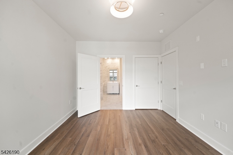 434 Springfield Avenue, Unit 123 Berkeley Heights, NJ 07922 - Photo 21 of 24 a view of a room with wooden floor and white walls