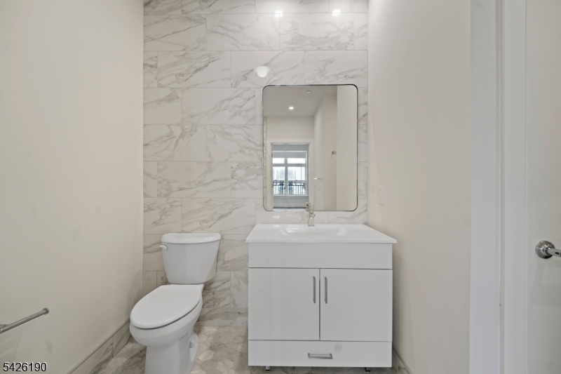 434 Springfield Avenue, Unit 123 Berkeley Heights, NJ 07922 - Photo 23 of 24 a bathroom with a toilet sink and mirror