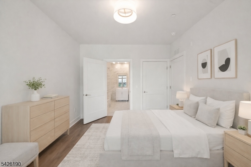 434 Springfield Avenue, Unit 123 Berkeley Heights, NJ 07922 - Photo 7 of 24 a spacious bedroom with a bed and a cabinets
