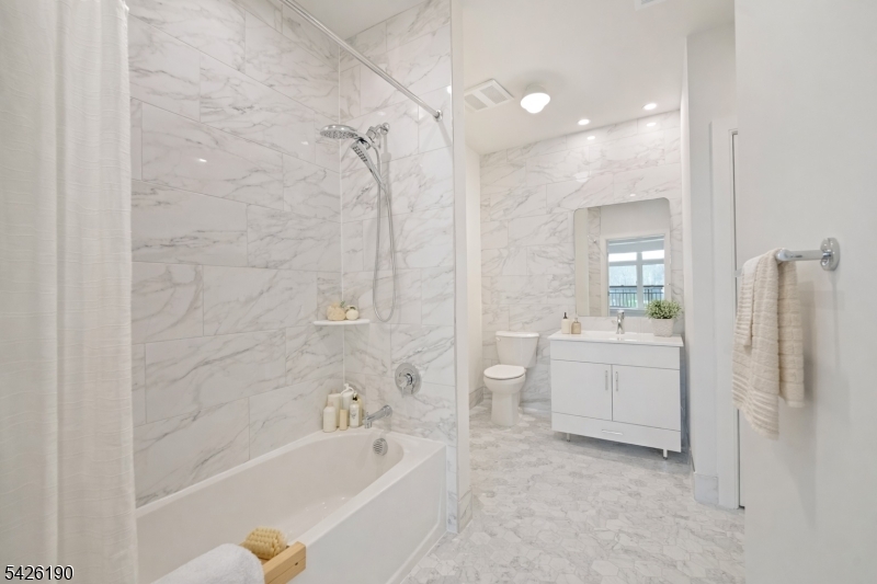 434 Springfield Avenue, Unit 123 Berkeley Heights, NJ 07922 - Photo 8 of 24 a bathroom with a tub a sink a mirror and a shower