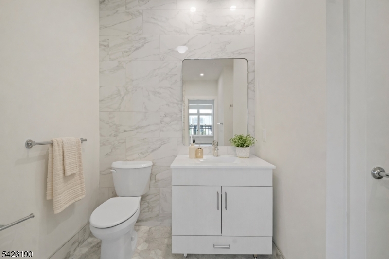 434 Springfield Avenue, Unit 123 Berkeley Heights, NJ 07922 - Photo 9 of 24 a bathroom with a toilet sink and mirror