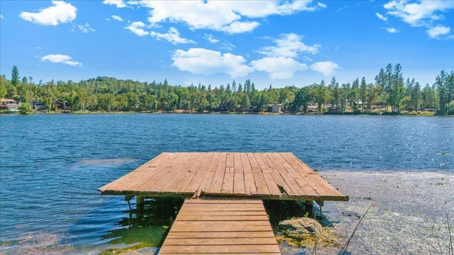 a view of a house with yard and lake view