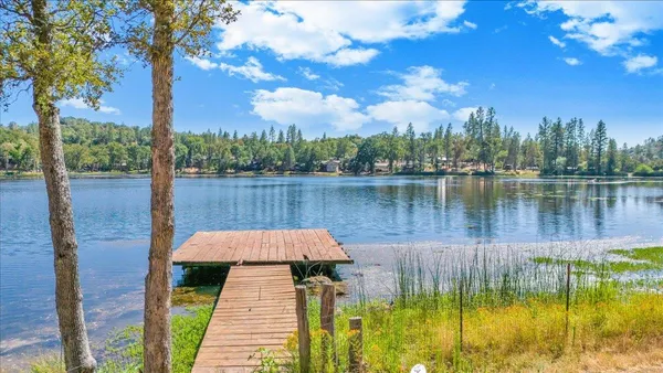 a view of a lake with houses in the back