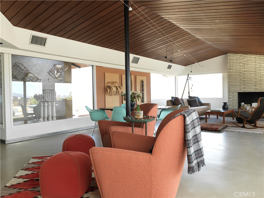 5960 Sunrise Road Twentynine Palms, CA 92277 - Photo 16 of 65 a living room with furniture a fireplace and a large window