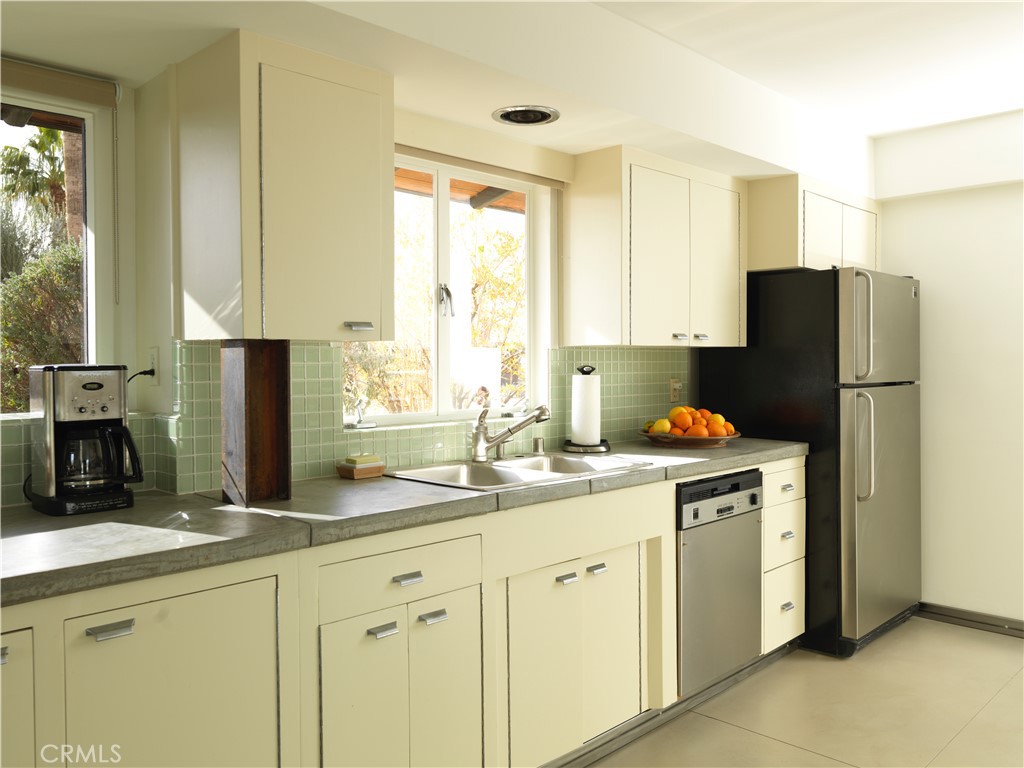 5960 Sunrise Road Twentynine Palms, CA 92277 - Photo 25 of 65 a kitchen with a refrigerator and a sink