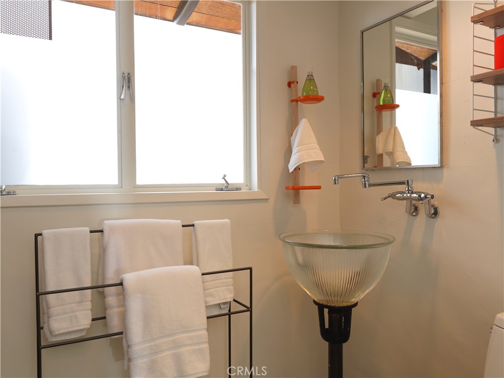 5960 Sunrise Road Twentynine Palms, CA 92277 - Photo 30 of 65 a bathroom with a sink and mirror