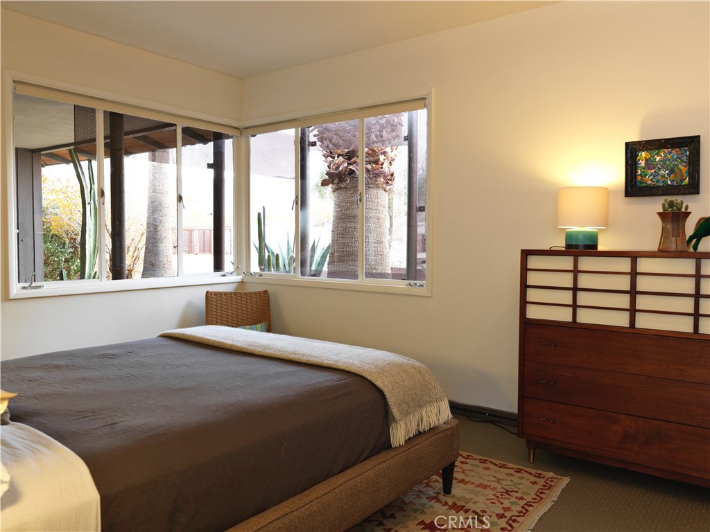 5960 Sunrise Road Twentynine Palms, CA 92277 - Photo 32 of 65 a bedroom with a bed and a large window