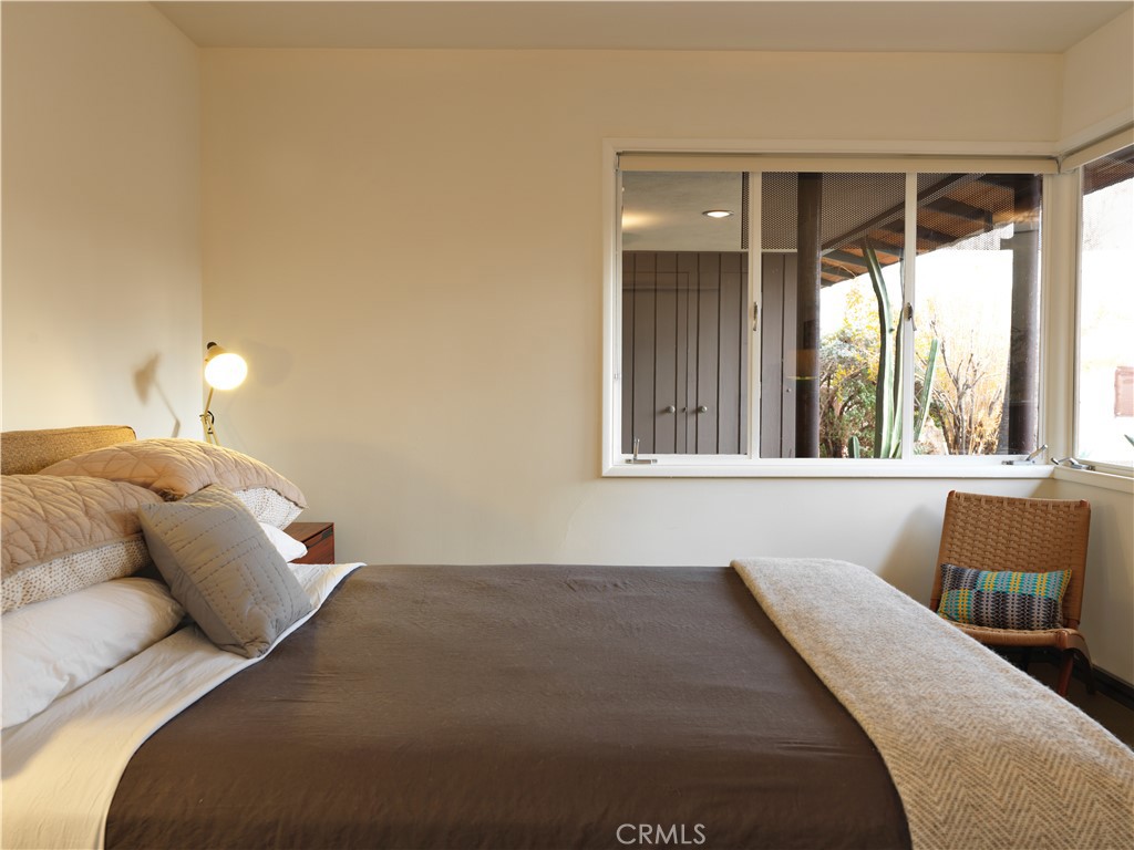 5960 Sunrise Road Twentynine Palms, CA 92277 - Photo 33 of 65 a bedroom with a bed and a large window