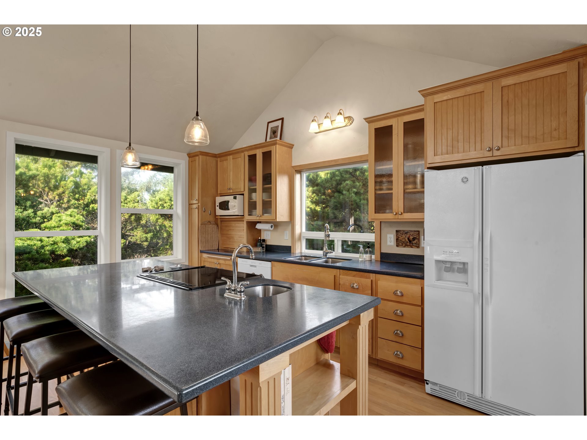 4567 Heceta Street Florence, OR 97439 - Photo 17 of 46 a kitchen with a table chairs and refrigerator