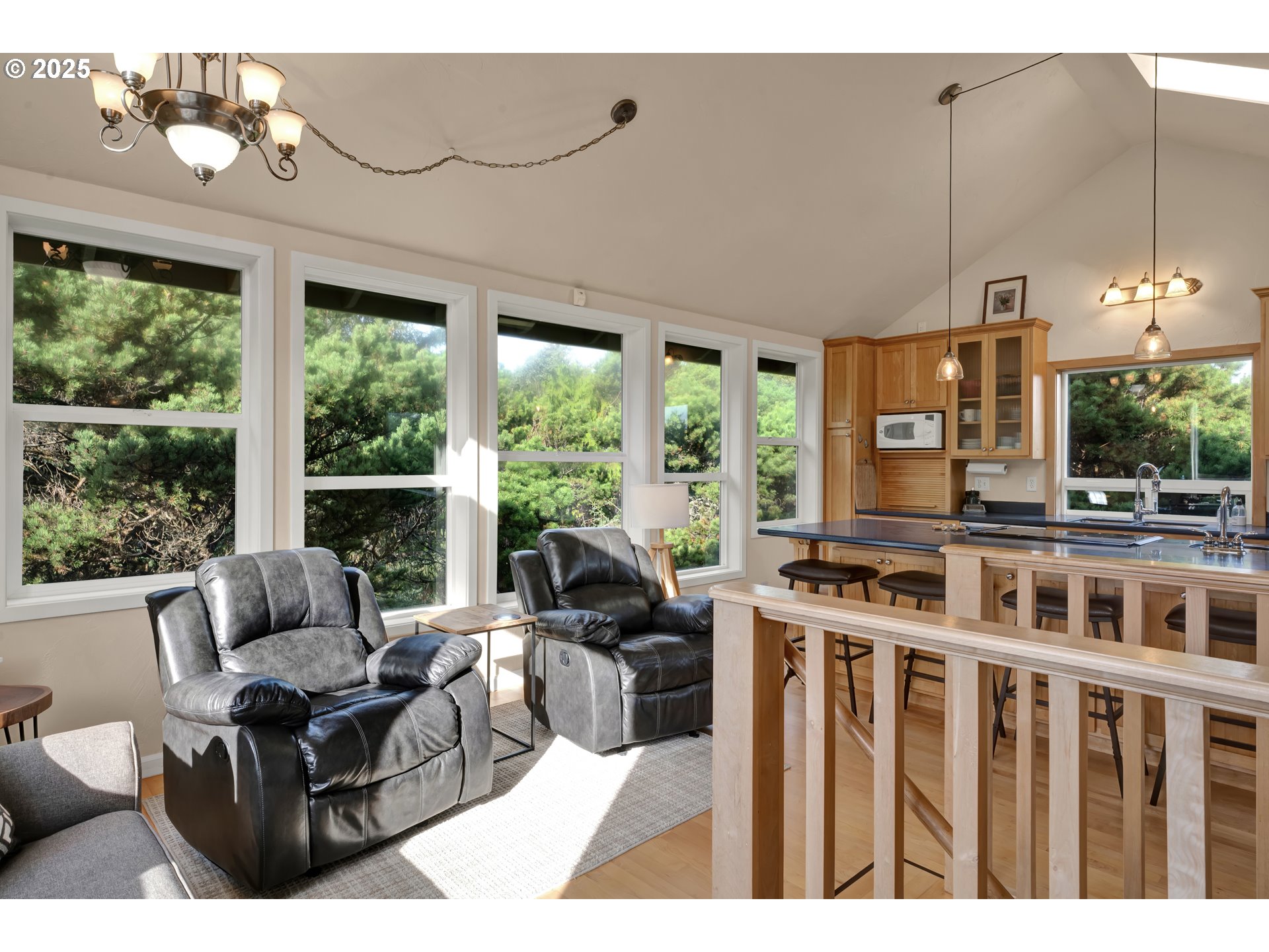 4567 Heceta Street Florence, OR 97439 - Photo 23 of 46 a living room with furniture a chandelier and a floor to ceiling window