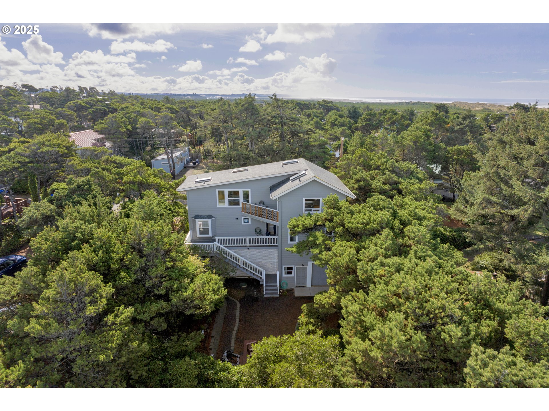 4567 Heceta Street Florence, OR 97439 - Photo 44 of 46 a view of a houses with a yard and mountain in the background