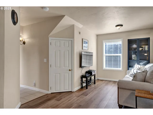 a living room with furniture and window with wooden floor