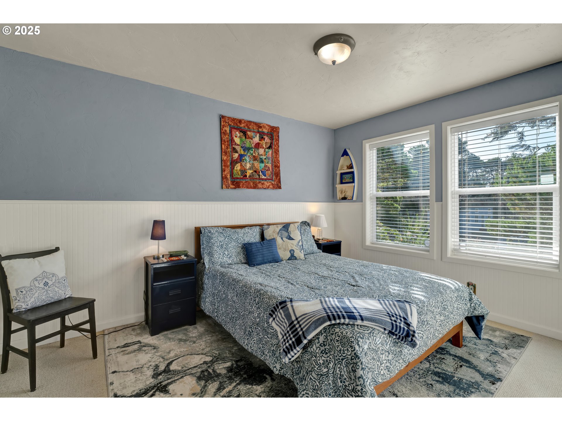 4567 Heceta Street Florence, OR 97439 - Photo 10 of 46 a bed sitting in a bedroom next to a window