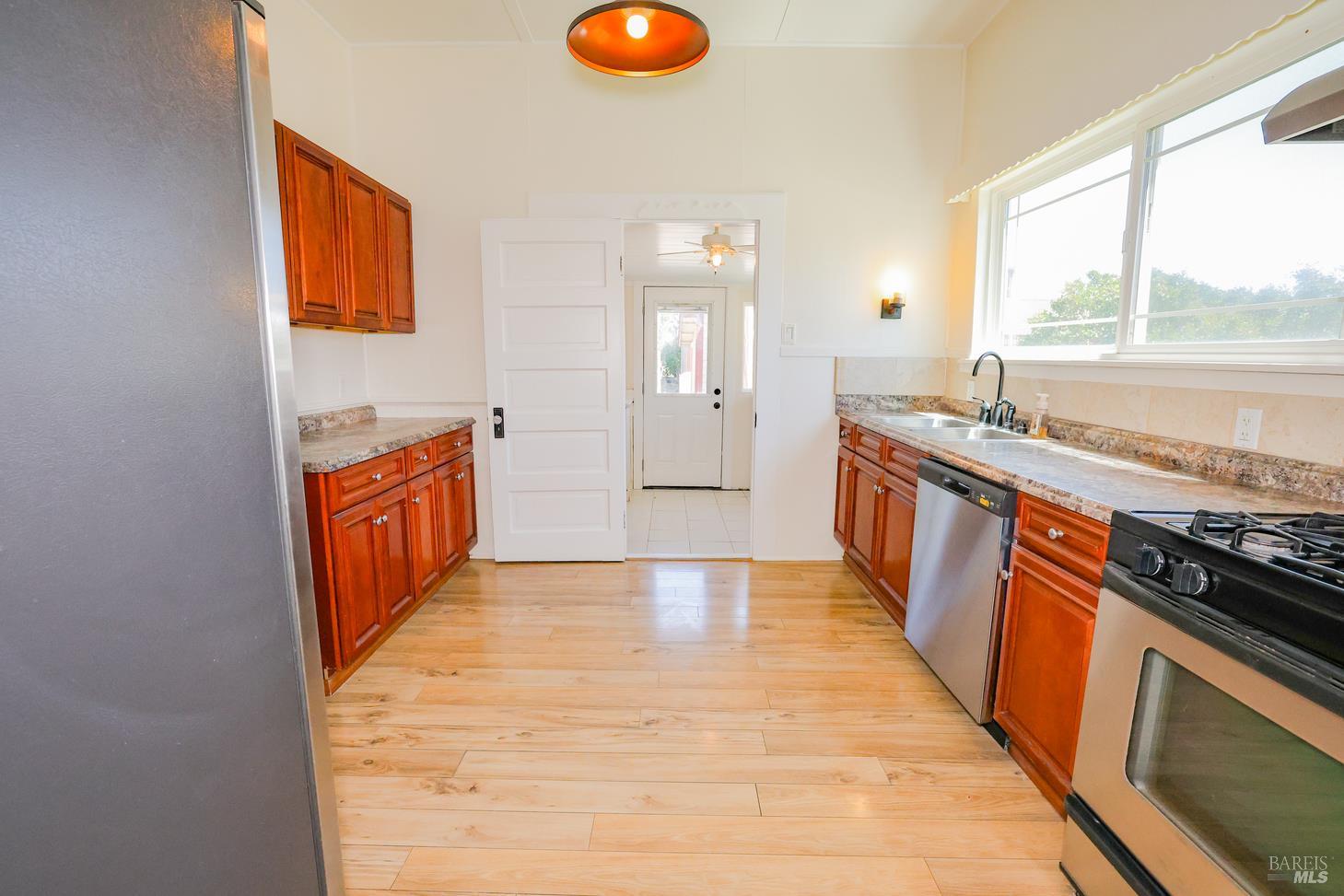 7948 North Meridian Road Dixon, CA 95620 - Photo 16 of 59 a large kitchen with stainless steel appliances granite countertop a stove a sink and a refrigerator