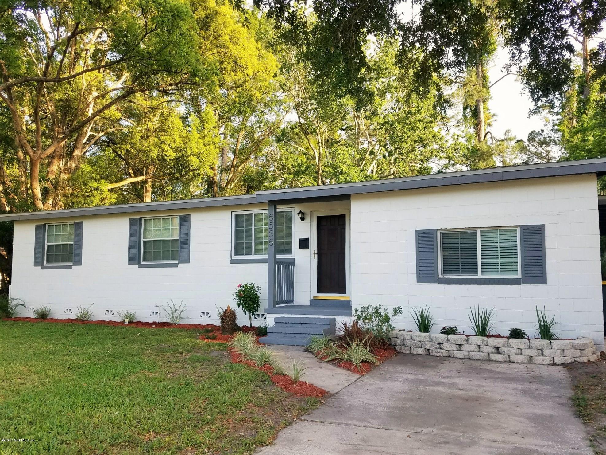 6556 Todd Road Jacksonville, FL 32216 - Photo 1 of 17 a house with trees in the background