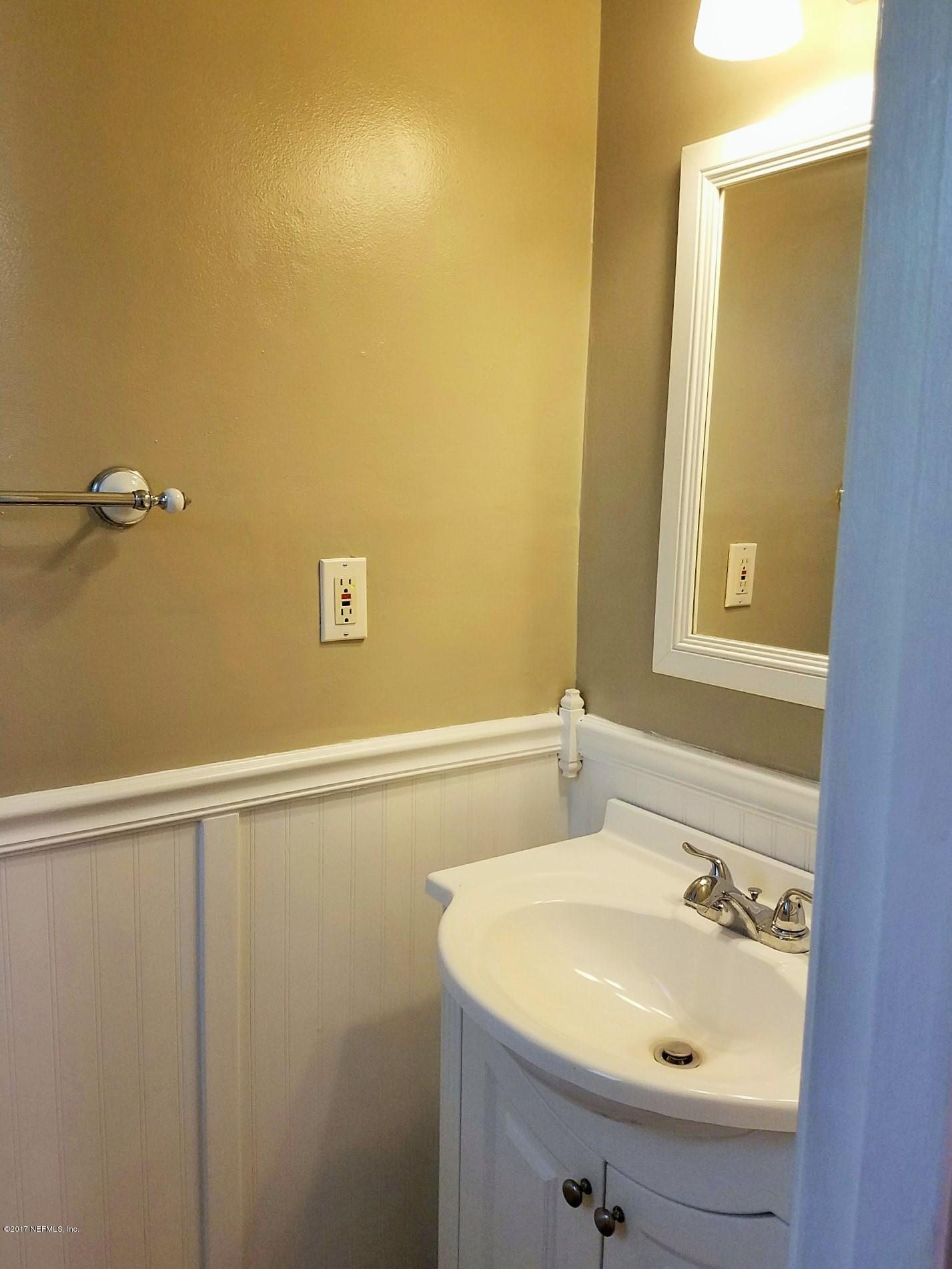 6556 Todd Road Jacksonville, FL 32216 - Photo 11 of 17 a bathroom with a sink and a mirror