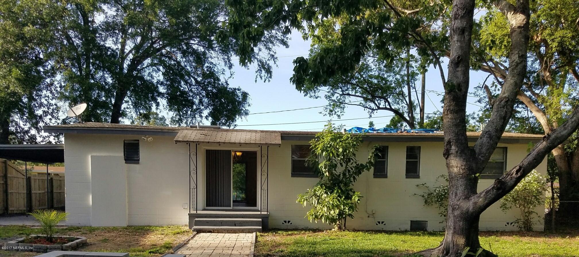 6556 Todd Road Jacksonville, FL 32216 - Photo 13 of 17 a backyard of a house with potted plants and large tree