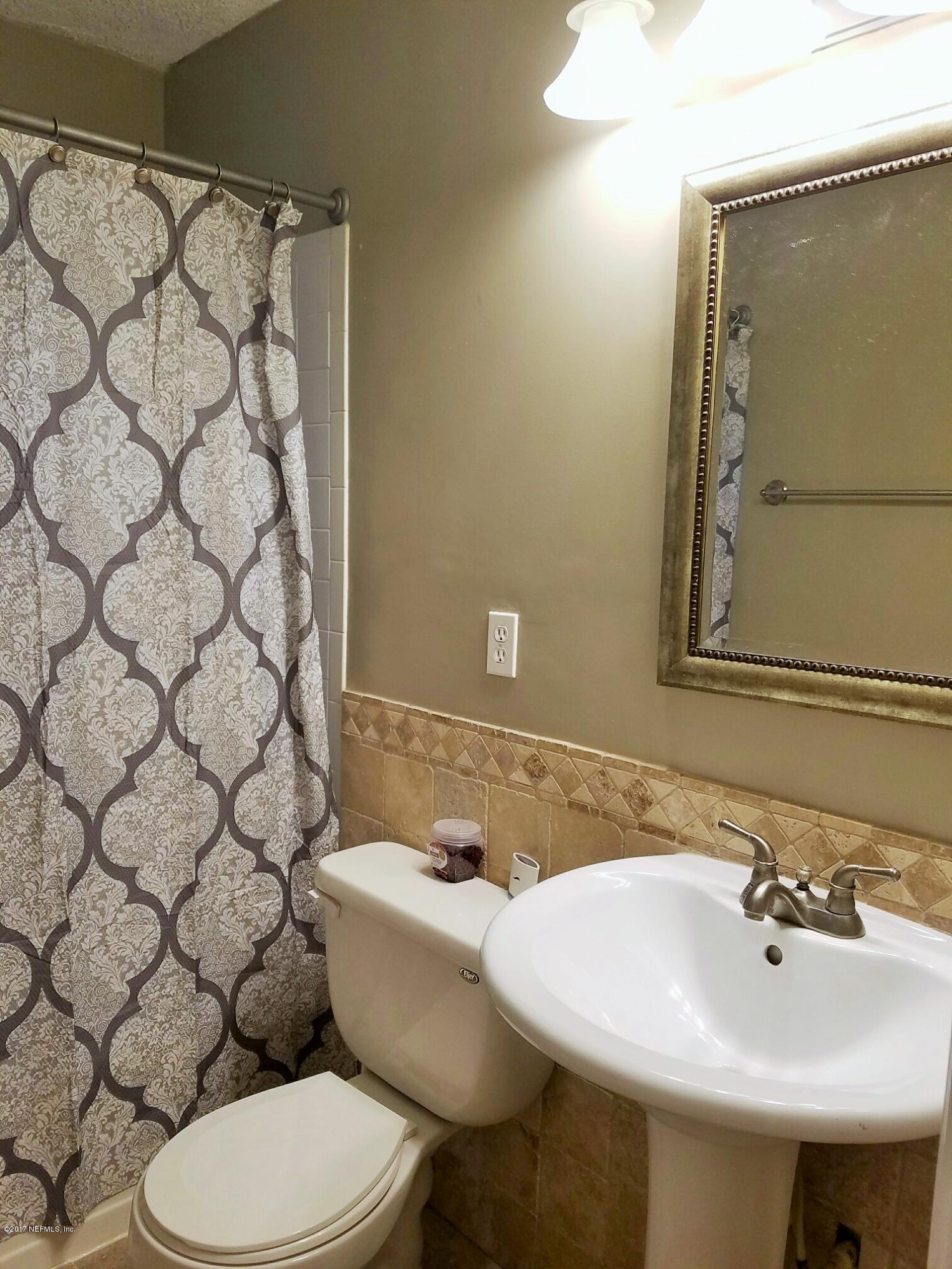 6556 Todd Road Jacksonville, FL 32216 - Photo 17 of 17 a bathroom with a sink and a mirror