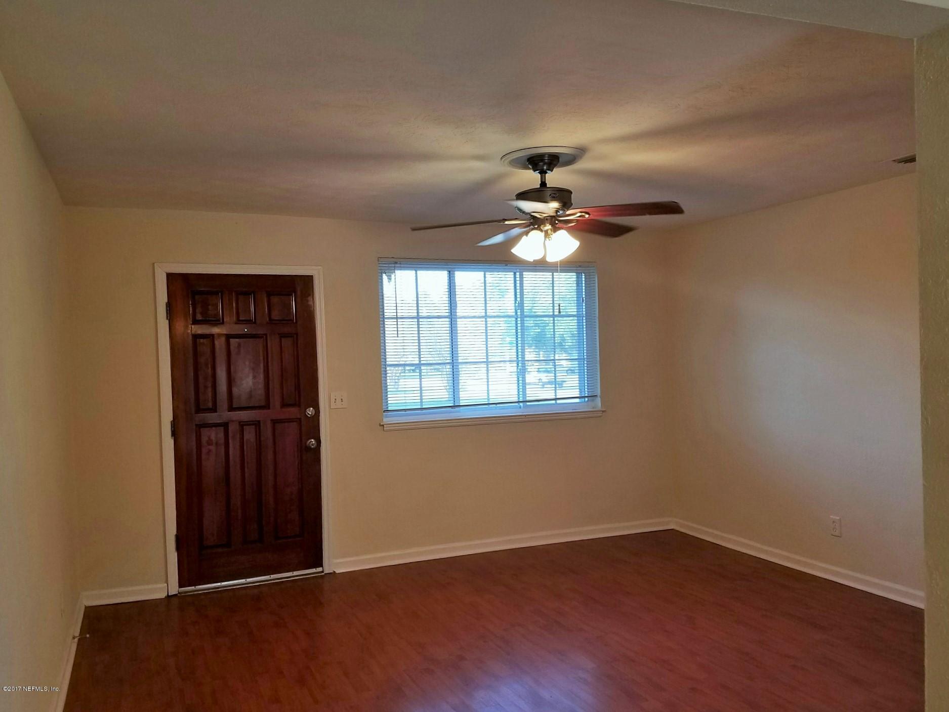 6556 Todd Road Jacksonville, FL 32216 - Photo 2 of 17 wooden floor in an empty room with a window
