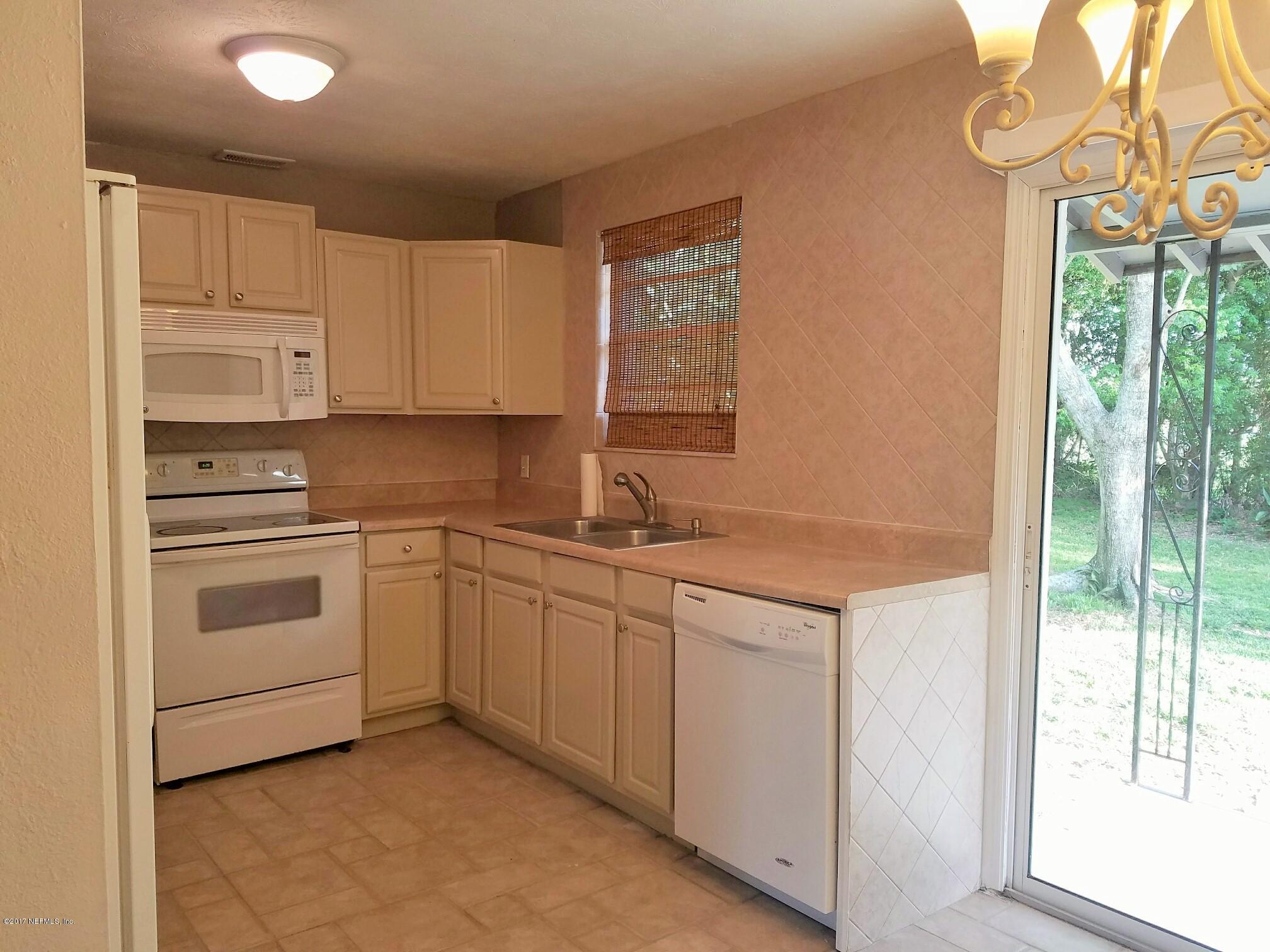 6556 Todd Road Jacksonville, FL 32216 - Photo 3 of 17 a kitchen with granite countertop white cabinets and white appliances