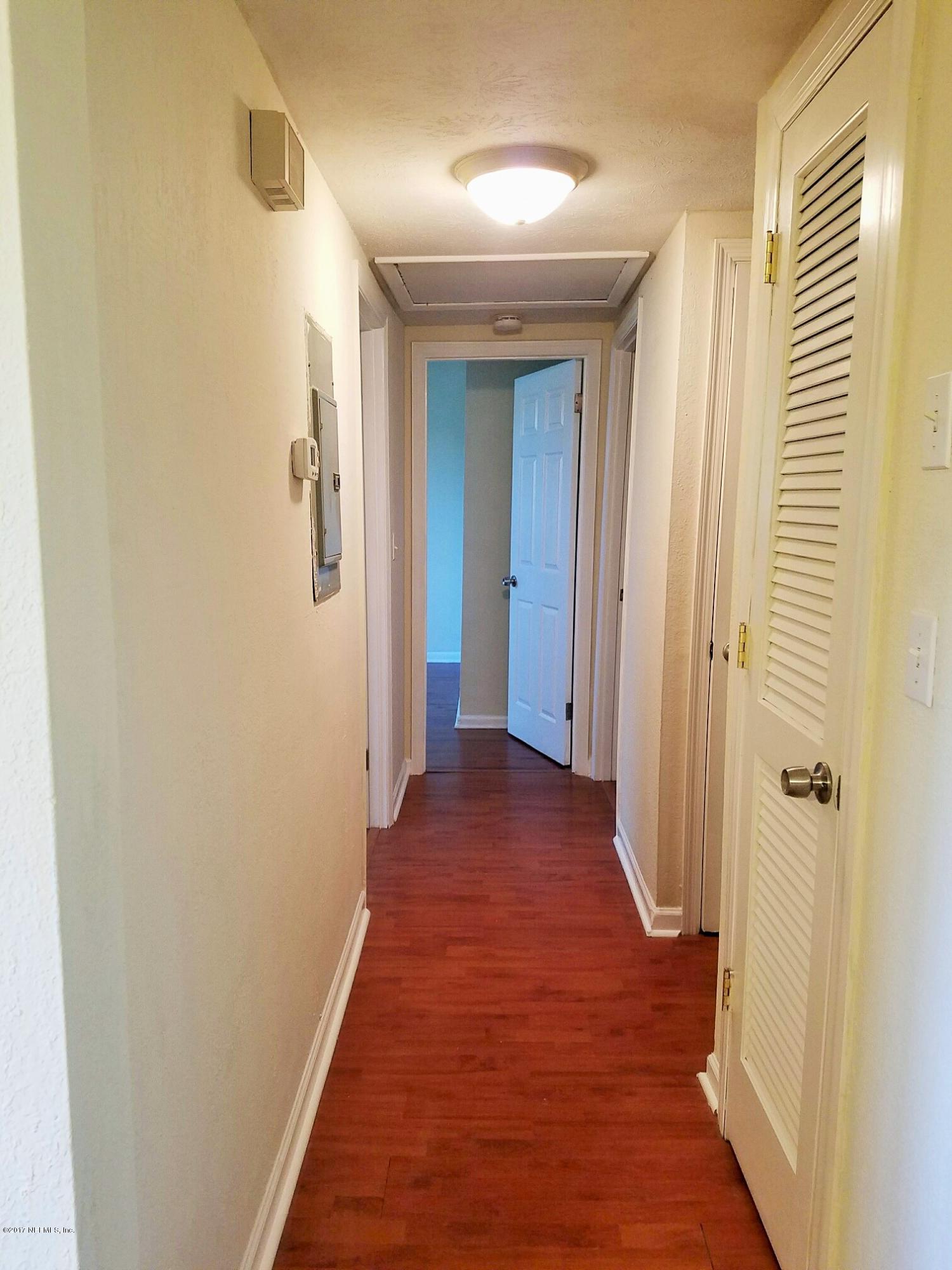 6556 Todd Road Jacksonville, FL 32216 - Photo 7 of 17 a view of a hallway with wooden floor