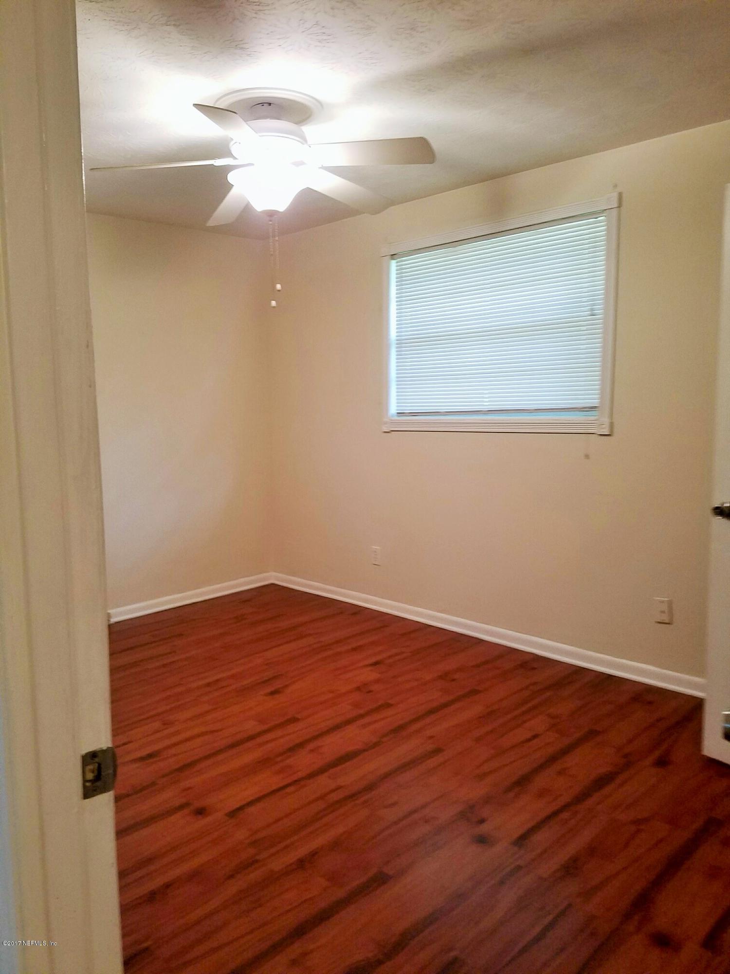 6556 Todd Road Jacksonville, FL 32216 - Photo 8 of 17 a view of empty room with wooden floor