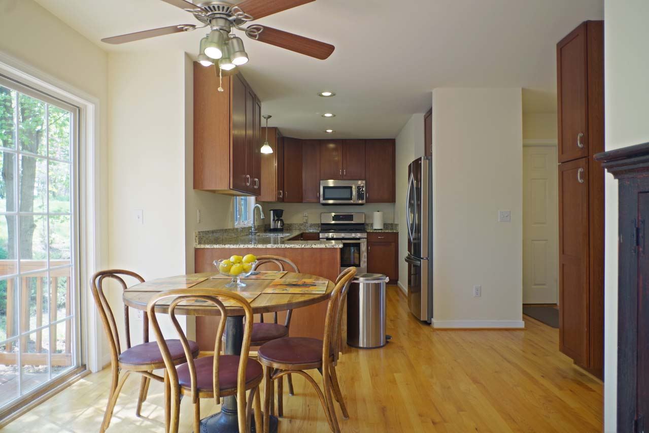 2009 Shepherds Ridge Road Charlottesville, VA 22901 - Photo 14 of 41 a kitchen with stainless steel appliances granite countertop a refrigerator a stove a sink dishwasher with a dining table and chairs