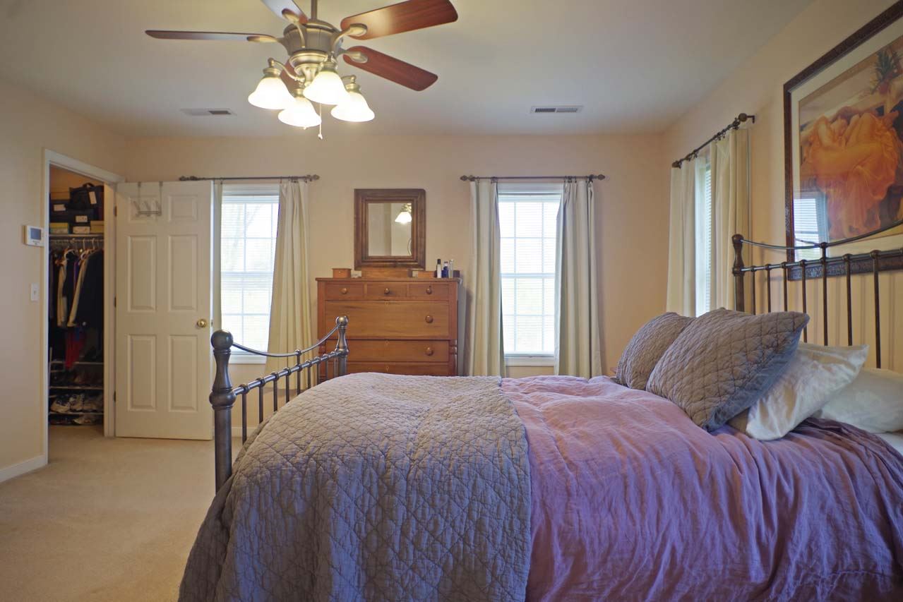 2009 Shepherds Ridge Road Charlottesville, VA 22901 - Photo 24 of 41 a bedroom with a bed and a chandelier