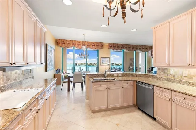 a large white kitchen with a large window