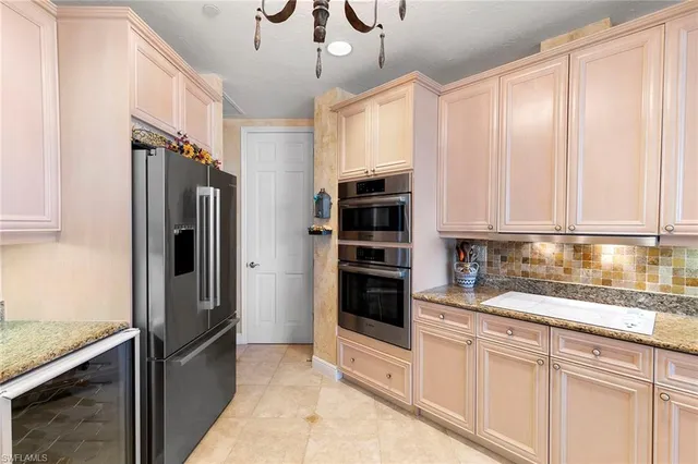 a kitchen with stainless steel appliances granite countertop a refrigerator and a sink