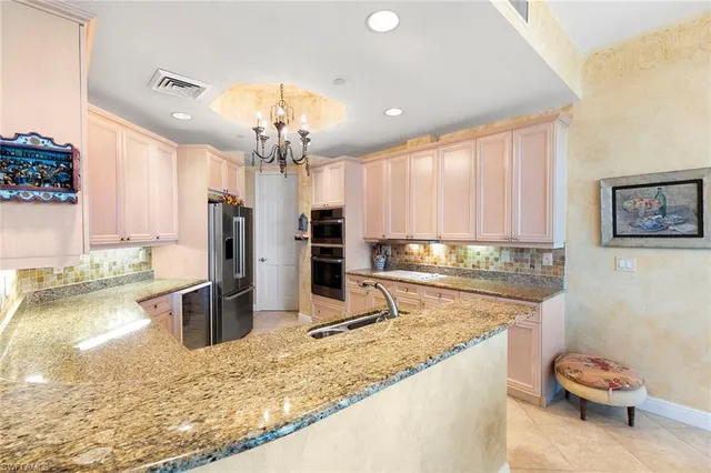 a kitchen with a refrigerator and a sink